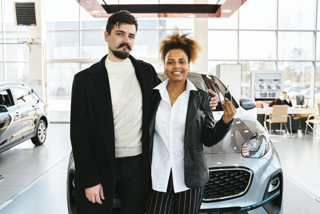 A happy couple buying a brand new car as a result of budgeting as a couple. 