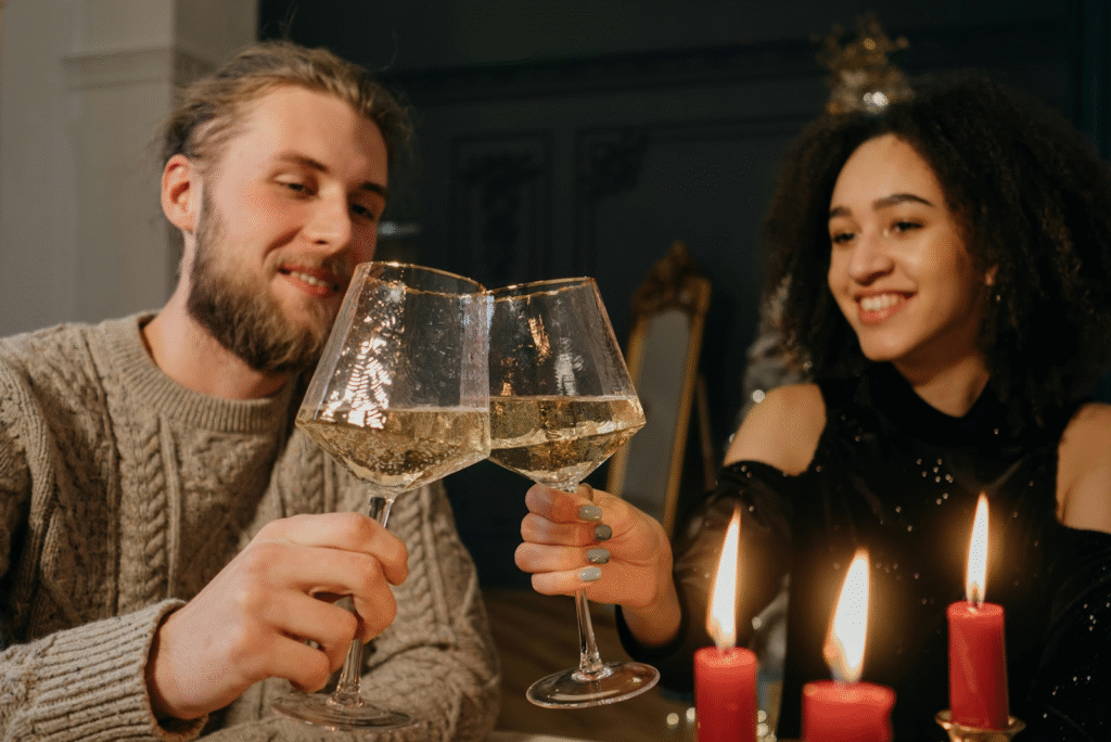 A couple toasting during a romantic date, showing how budgeting as a couple makes room for love and special moments. 