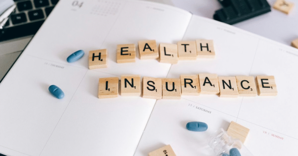  A wooden letter tile spelling “Health Insurance”, which is an example of financial goals to make money.