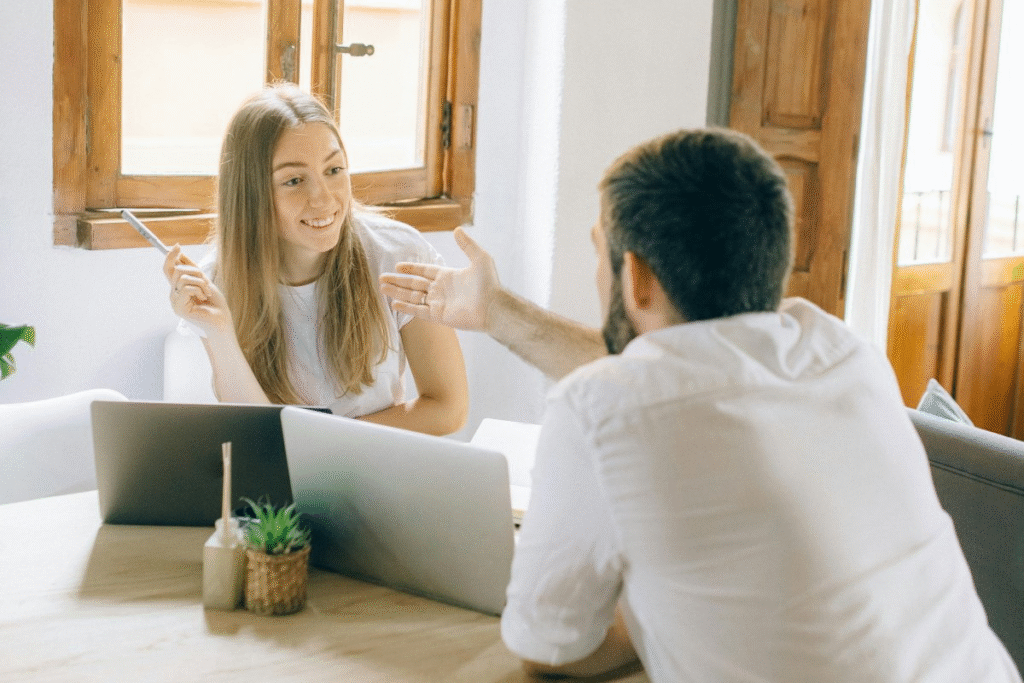 A couple having a discussion at home about how to split finances in marriage and manage their money together. 