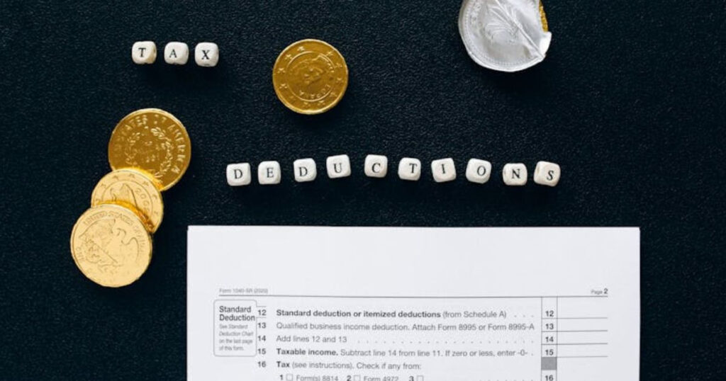 Gold round coins on black textiles alongside an important document necessary when filing taxes