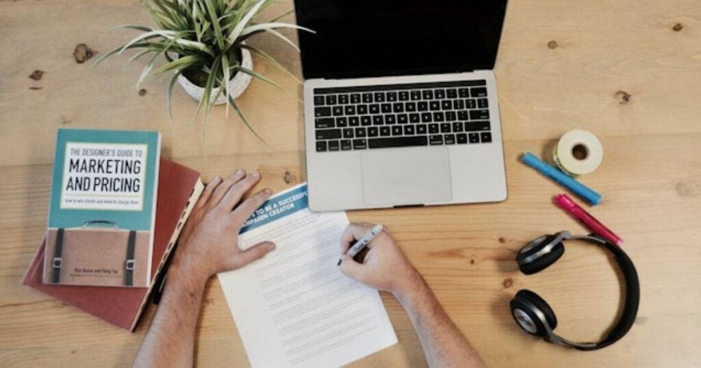 A picture showing a book with affiliate marketing with someone planning showing how to make money on YouTube