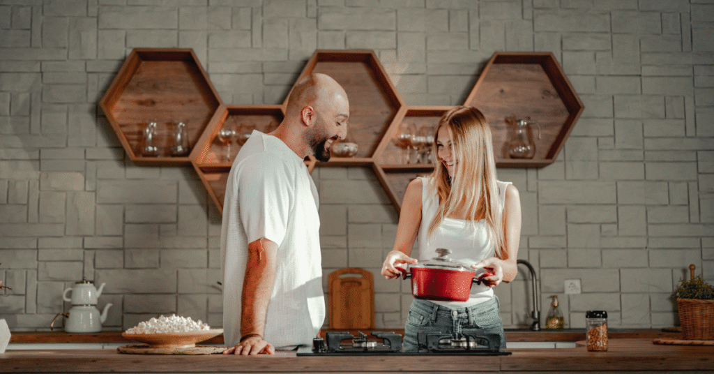 A picture showing couples in the kitchen admiring their buy it for life cookware