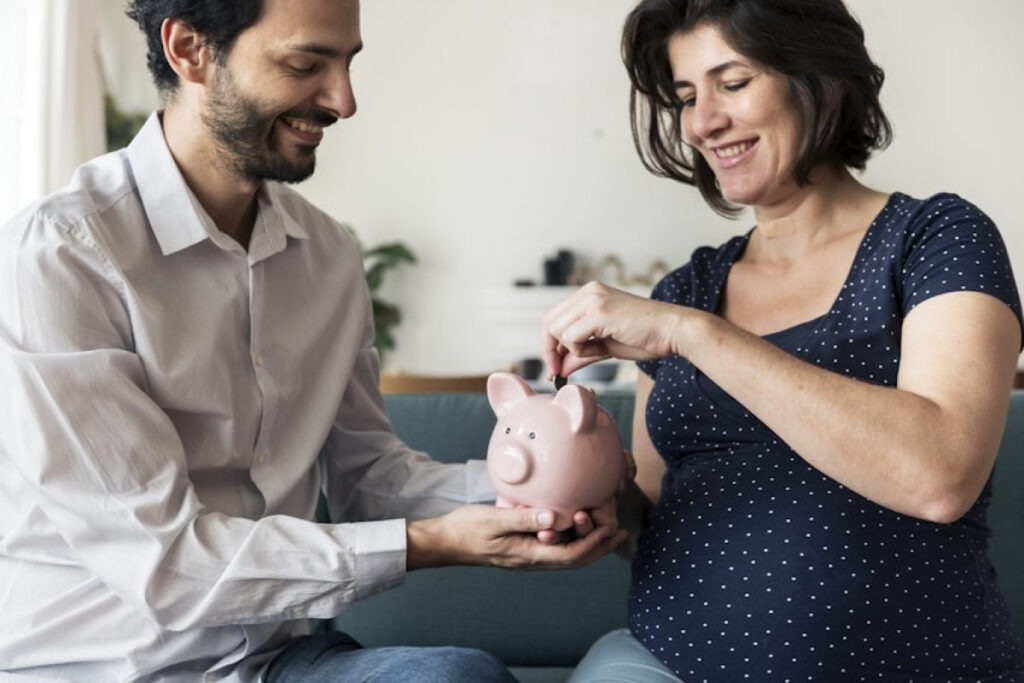 A picture showing a couple using the Three-Bucket System for Couples to plan and contribute household money together on a laptop.
