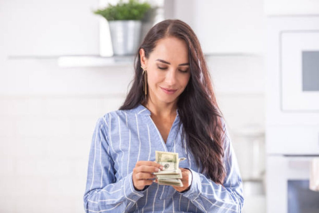 A picture showing a young wife calculating money, reflecting on her finances