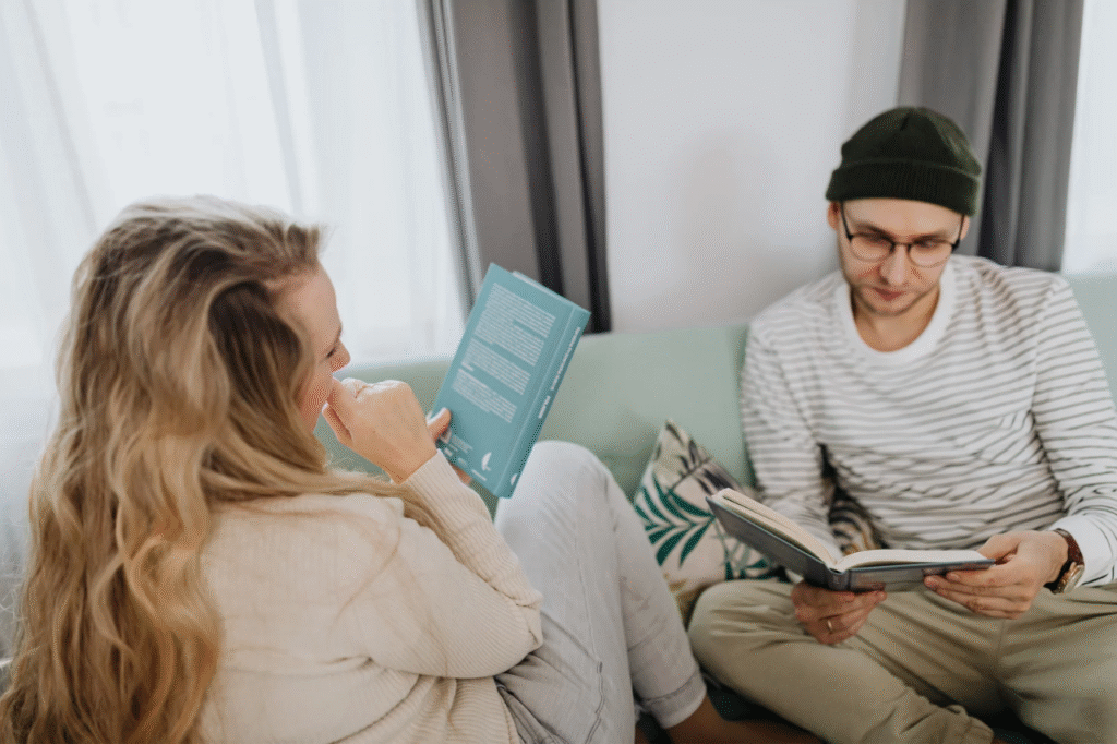 A picture showing Couples sitting across from each other and reading one of the best financial planning books for couples.