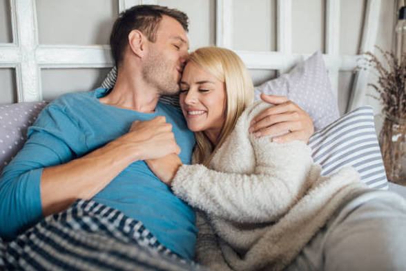 An image showing  A loving couple relaxing together after making financial adjustments with tips that help with affording a career change as a couple.