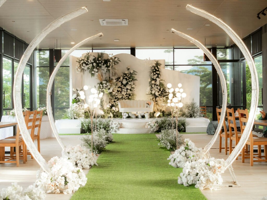 An image showing Elegant but small wedding venue setup with floral decorations and modern ceremony aisle for couples planning a wedding on a budget